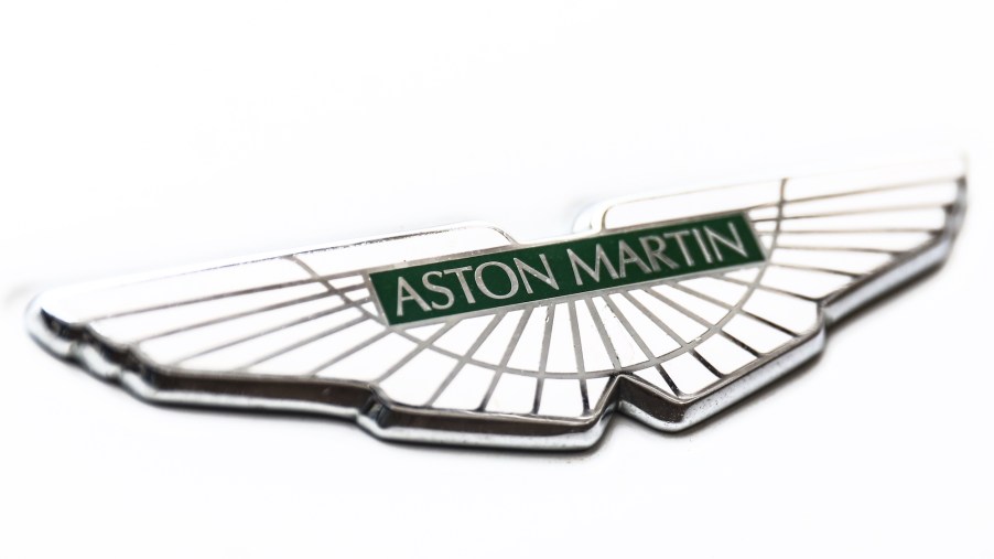 A white Aston Martin logo that is shared by the 2024 Aston Martin Vanquish.