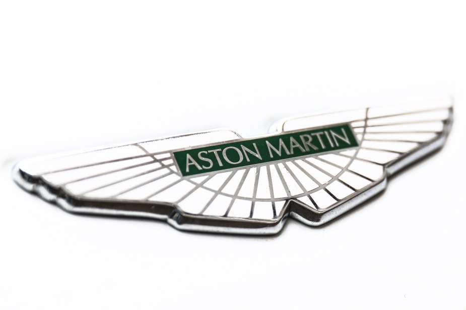 A white Aston Martin logo that is shared by the 2024 Aston Martin Vanquish. 