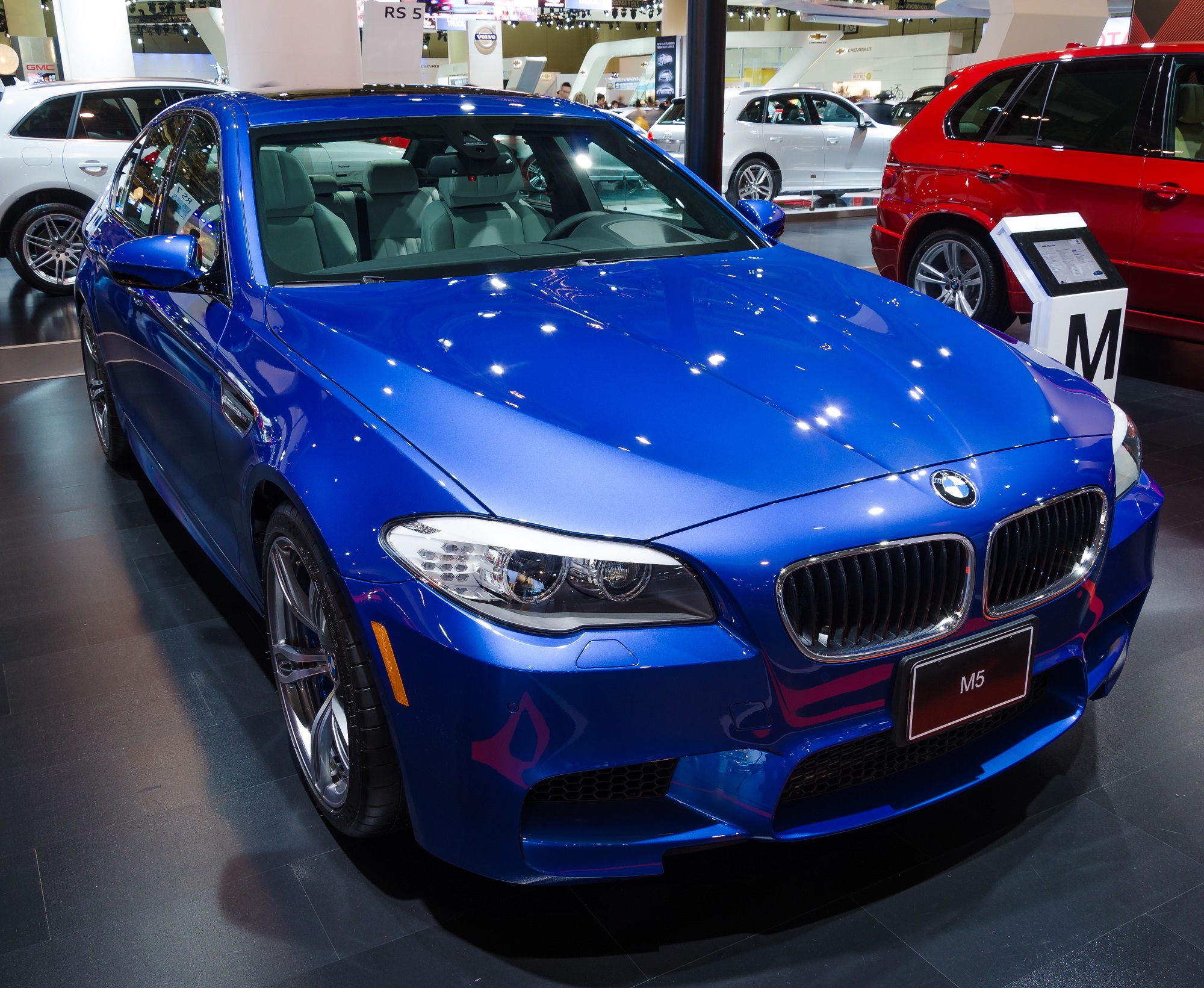 The BMW M5, like this blue one, is a used car faster than a Ford Mustang GT.