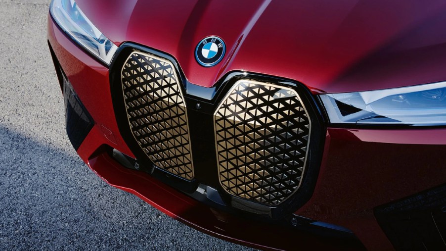 The front of a red BMW iX luxury electric midsize SUV.