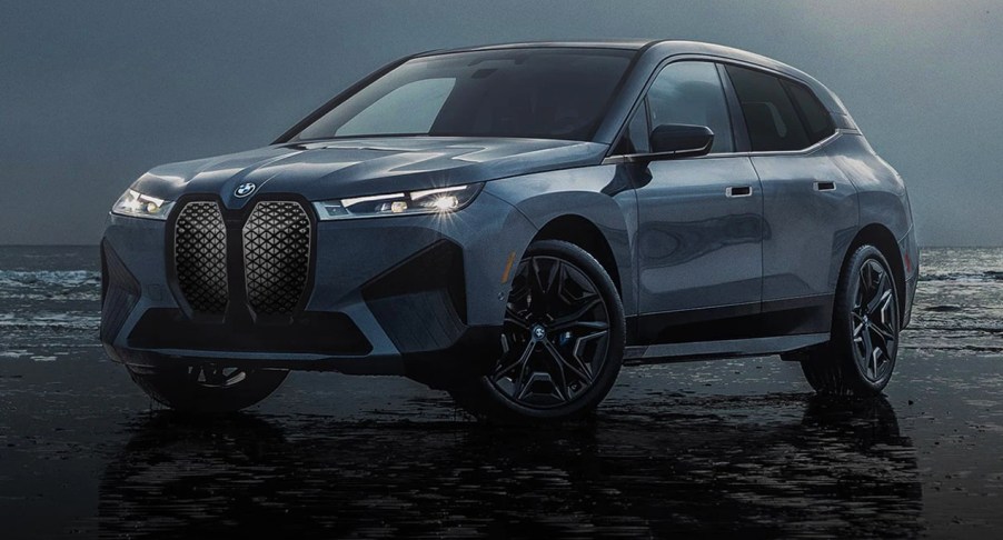 A blue BMW iX luxury midsize electric SUV is parked.