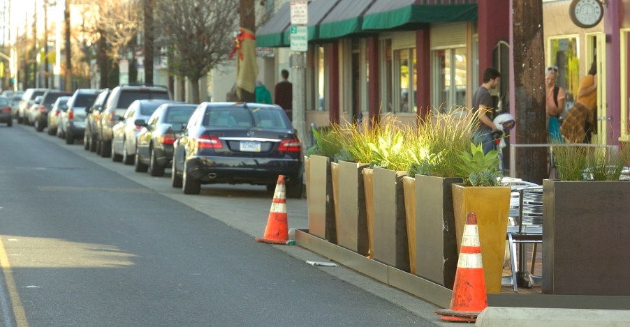 A group of people that know how to parallel park on the side of the road.