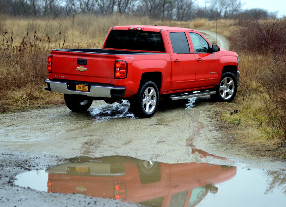 The rear end view of a 2016 Chevy Silverado 1500 in red.