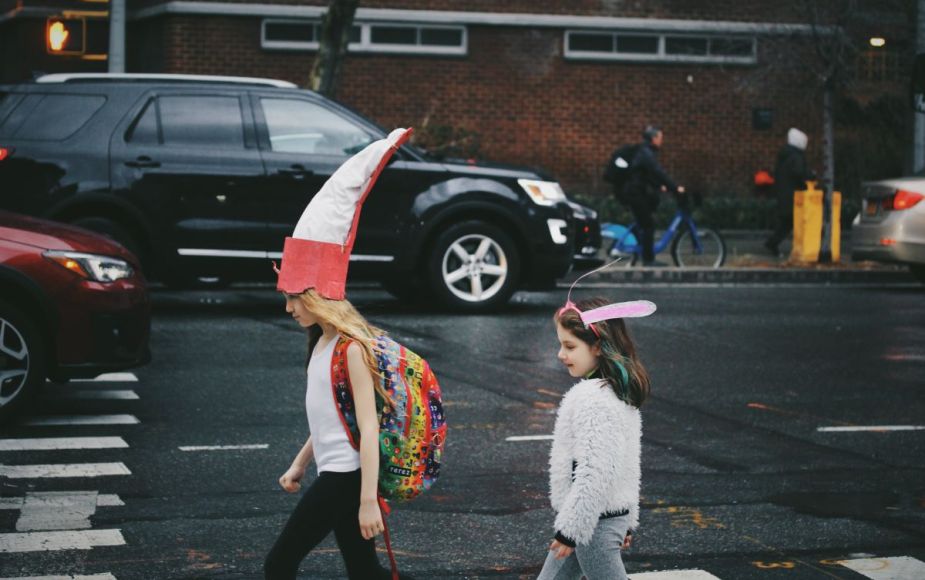 Children walking on a busy street, highlighting ways to reduce speeding in your neighborhood