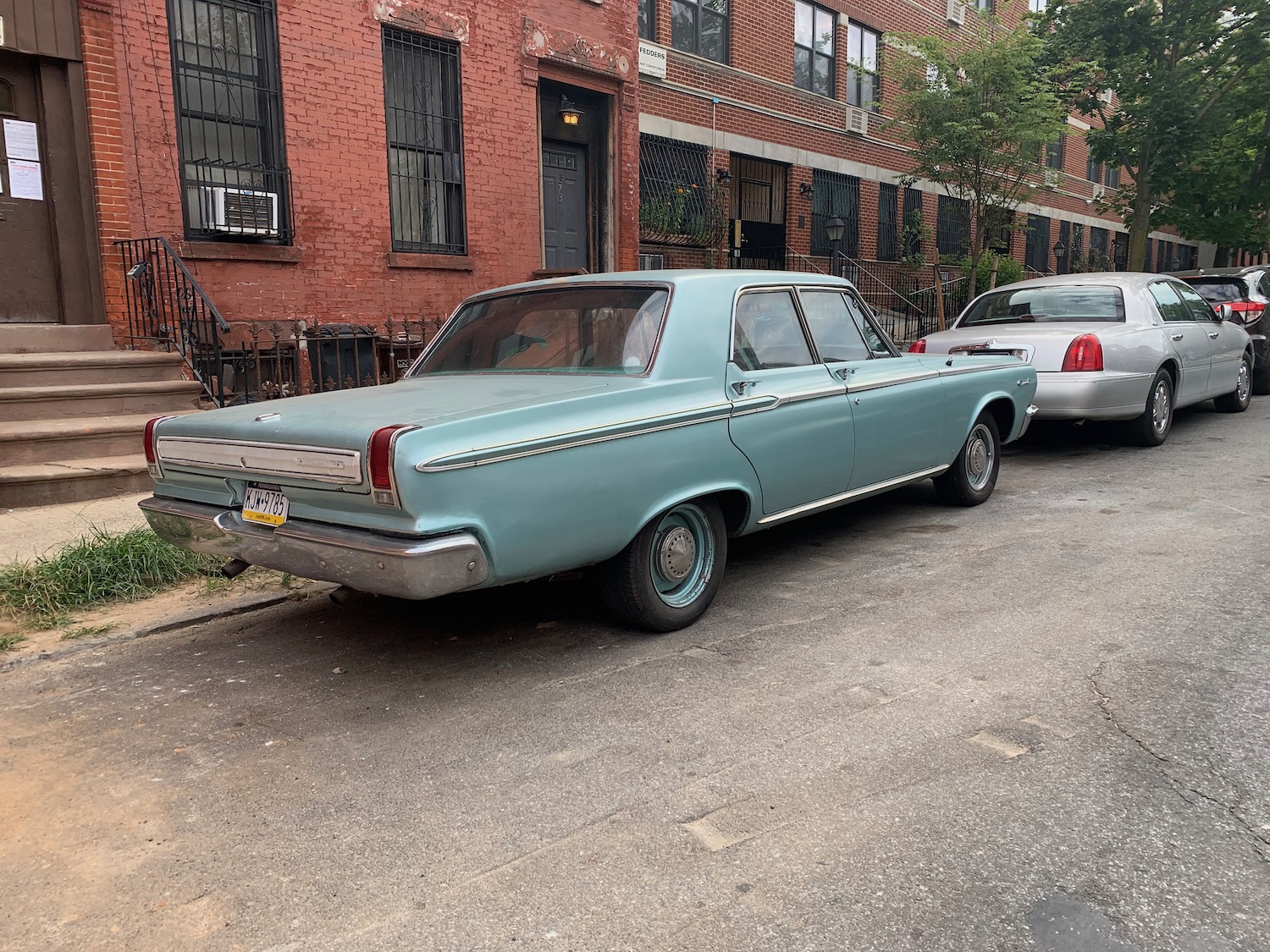Aqua colored Dodge 440 classic car in the city.