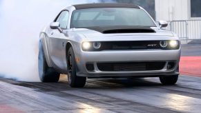 A 2023 Dodge Challenger SRT Demon 170 does a burnout at a drag strip.