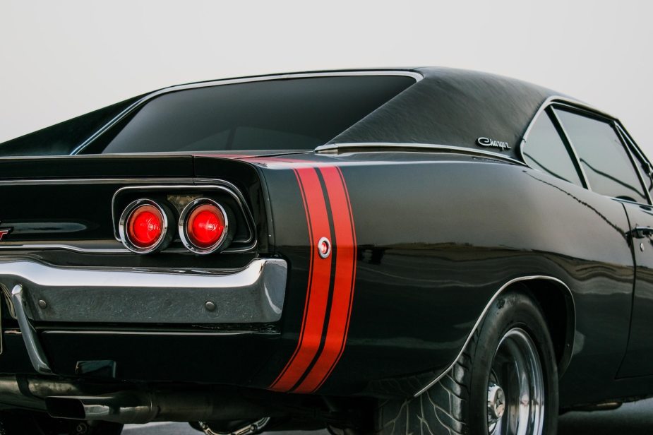 The taillights of a second-generation Dodge Charger muscle car: black with a red stripe.