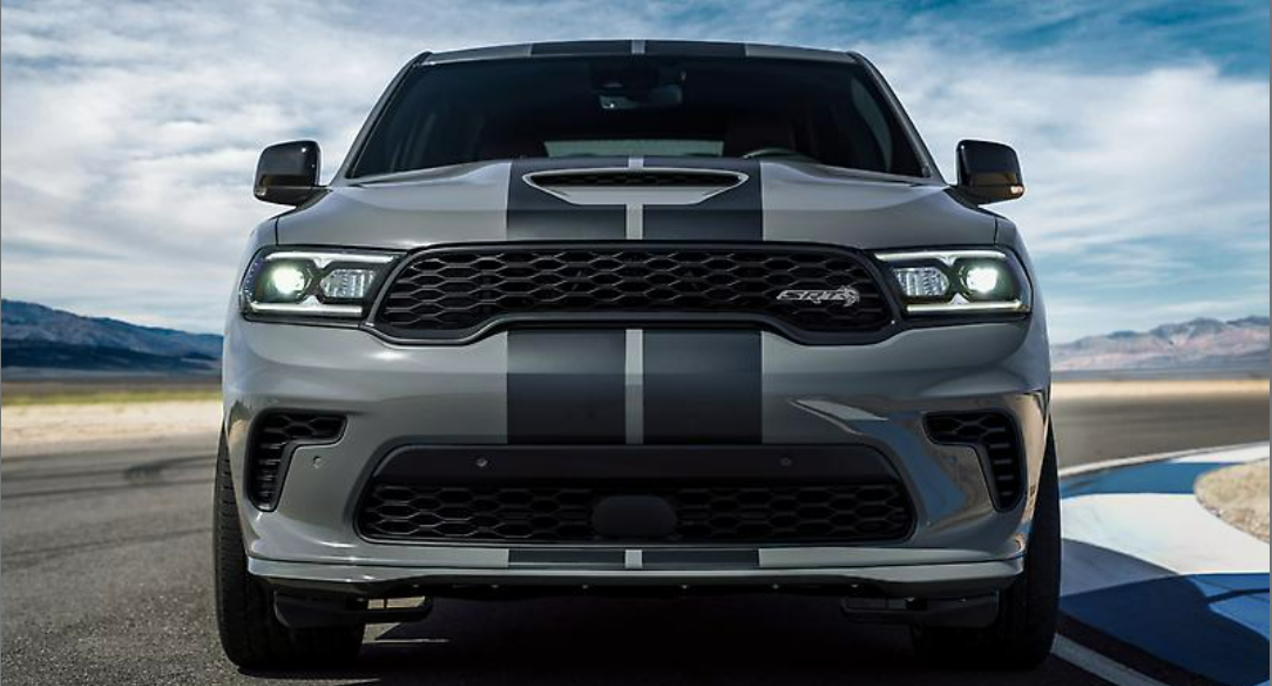 A gray Dodge Durango SRT Hellcat is driving on a track.