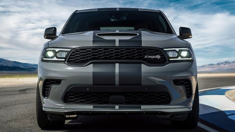 A gray Dodge Durango SRT Hellcat is driving on a track.