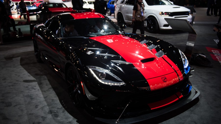 A black Dodge Viper with a red stripe down the center parked indoors.