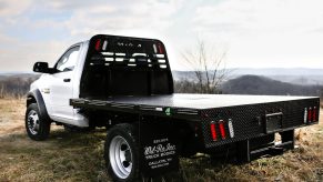 This is a heavy-duty Ram pickup truck with a Cummins engine modified by Wil-Ro inc. Truck Bodies with a custom stakeside flat bed.