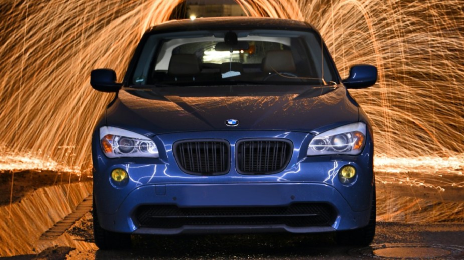 Fireworks exploding near a BMW X1, highlighting why loud noises like thunder make a car alarm go off