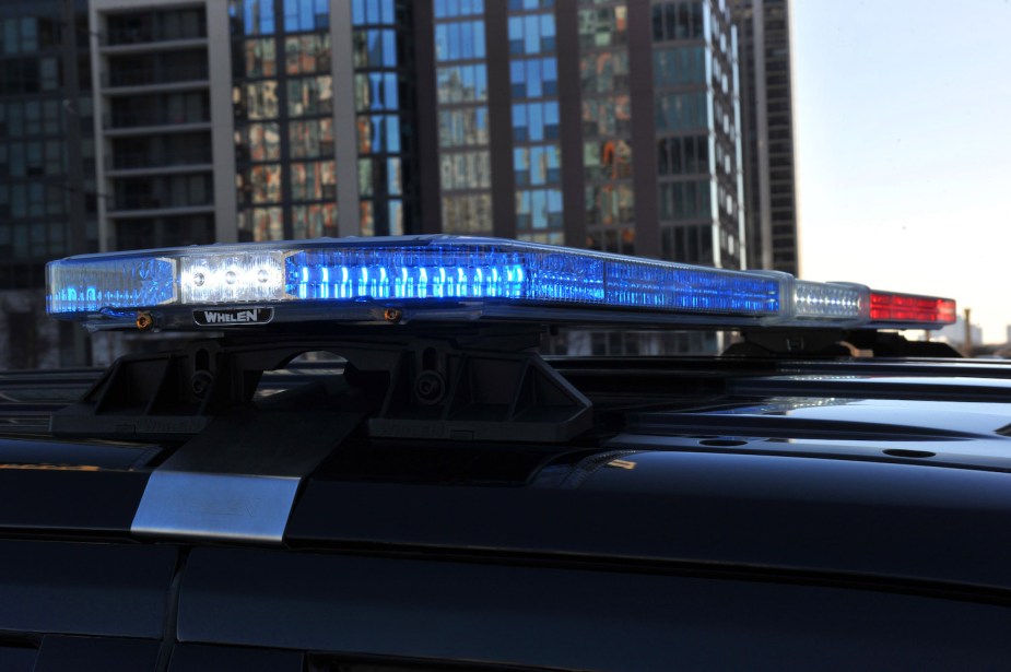 Closeup of the blue light side of a police car's light bar.