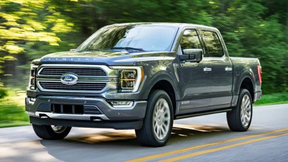 Gray Ford F-150 Limited Driving Down a Road