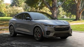 A gray 2023 Ford Mustang Mach-E electric SUV is parked.