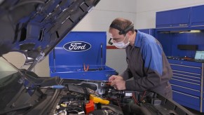 Ford Technician Working on a Vehicle Wearing the SWIS Headset
