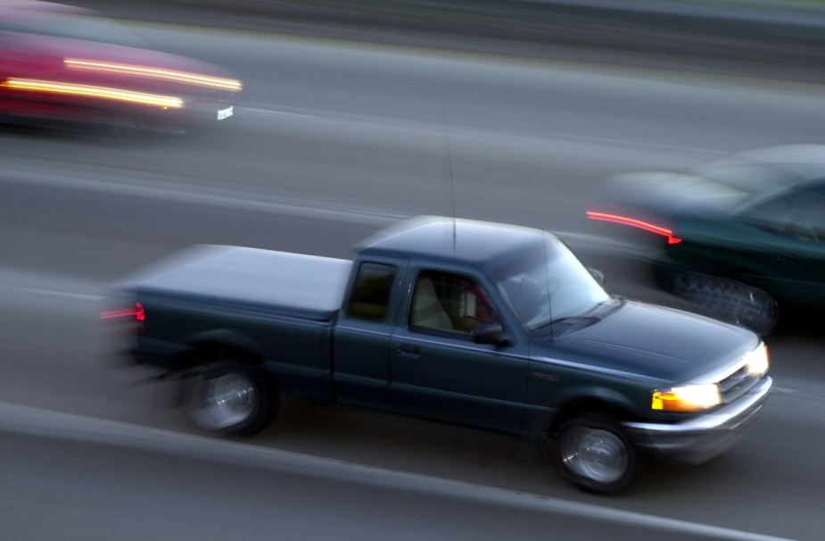 A third generation Ford Ranger drives in traffic.
