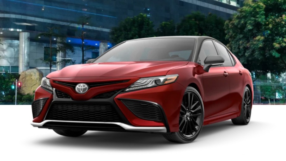 Front angle view of 2023 Toyota Camry midsize sedan with Supersonic Red/Midnight Black Metallic roof