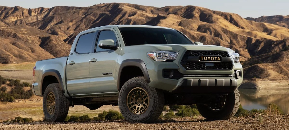 Front angle view of Lunar Rock 2023 Toyota Tacoma pickup truck with mountains in the background