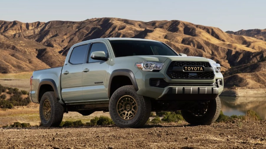 Front angle view of Lunar Rock 2023 Toyota Tacoma pickup truck with mountains in the background