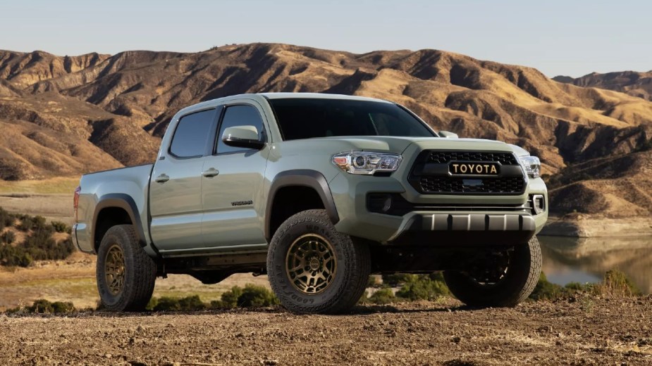 Front angle view of the 2023 Toyota Tacoma Lunar Rock pickup truck with mountains in the background