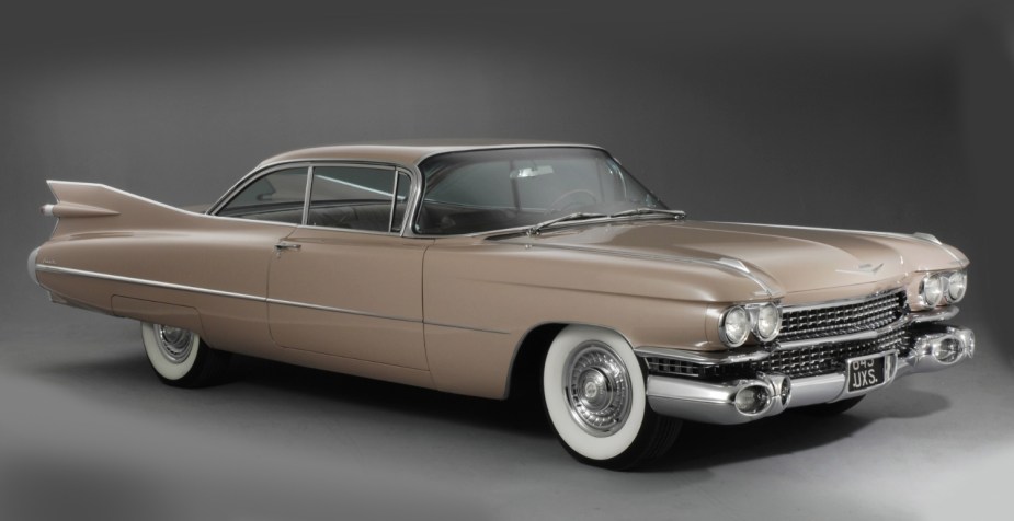 Front angle view of brown 1959 Cadillac Coupe De Ville, highlighting why car tires are black instead of white