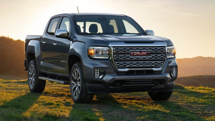 A gray 2022 GMC Canyon midsize pickup truck is parked outdoors.