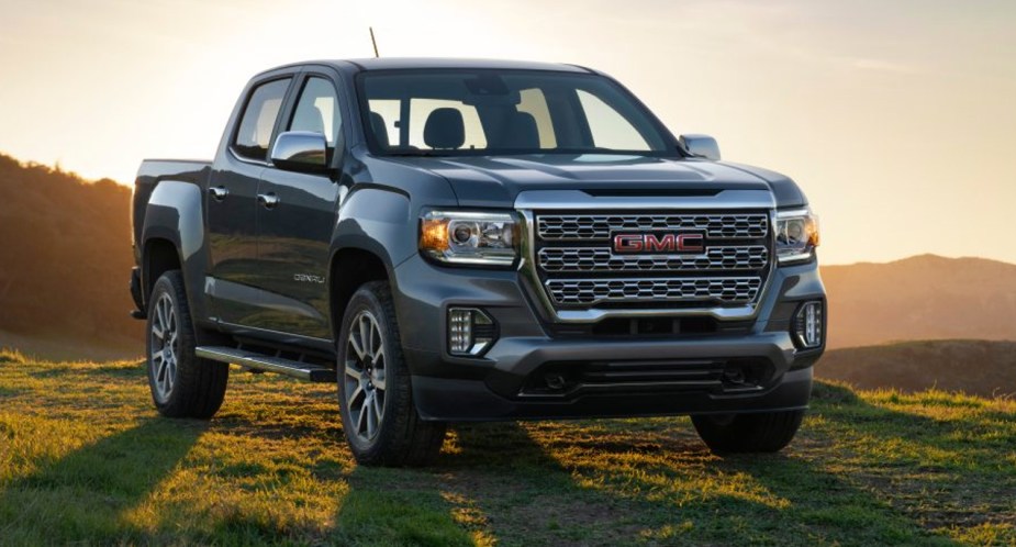 A gray 2022 GMC Canyon midsize pickup truck is parked outdoors.