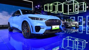 a blue Mach-E at an auto show