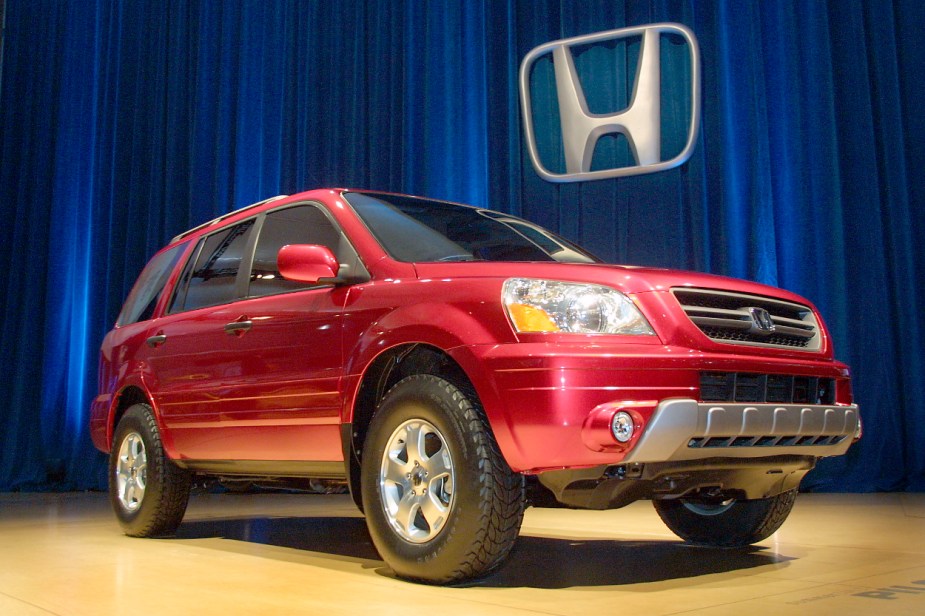 A red Honda Pilot SUV is on display.