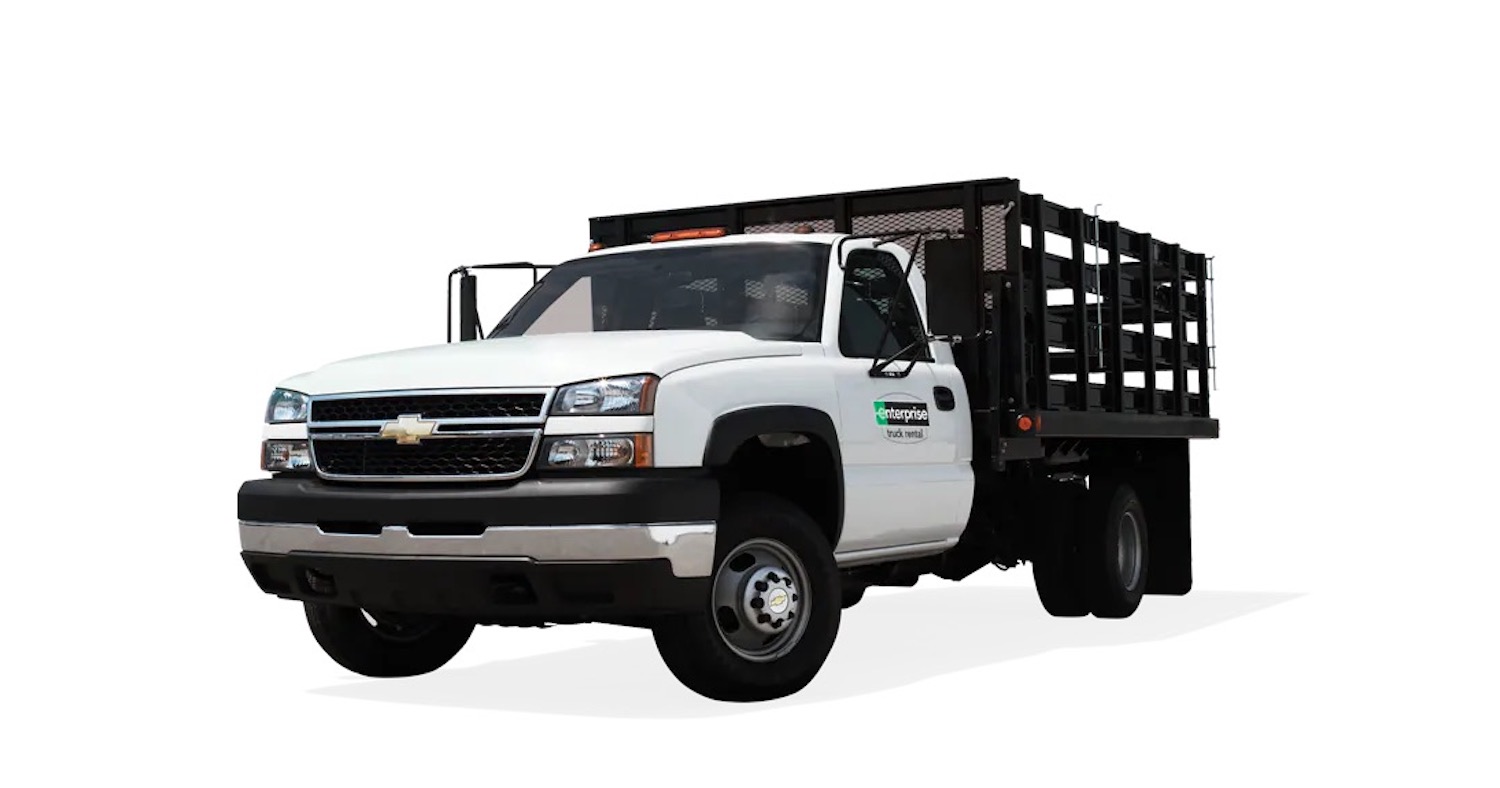 An Enterprise rental truck with a flat bed fit with stake sides for hauling bulky items.