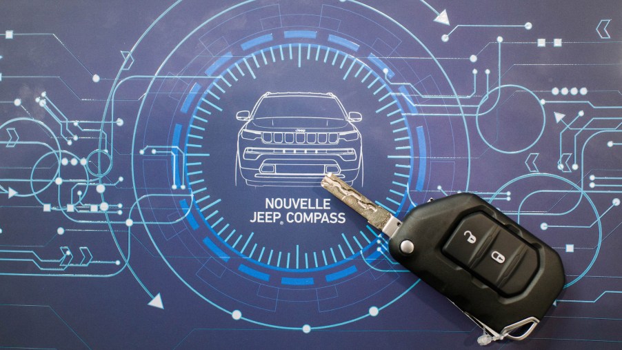 A depiction of a Jeep Compass in the form of a blueprint picture with a key fob.