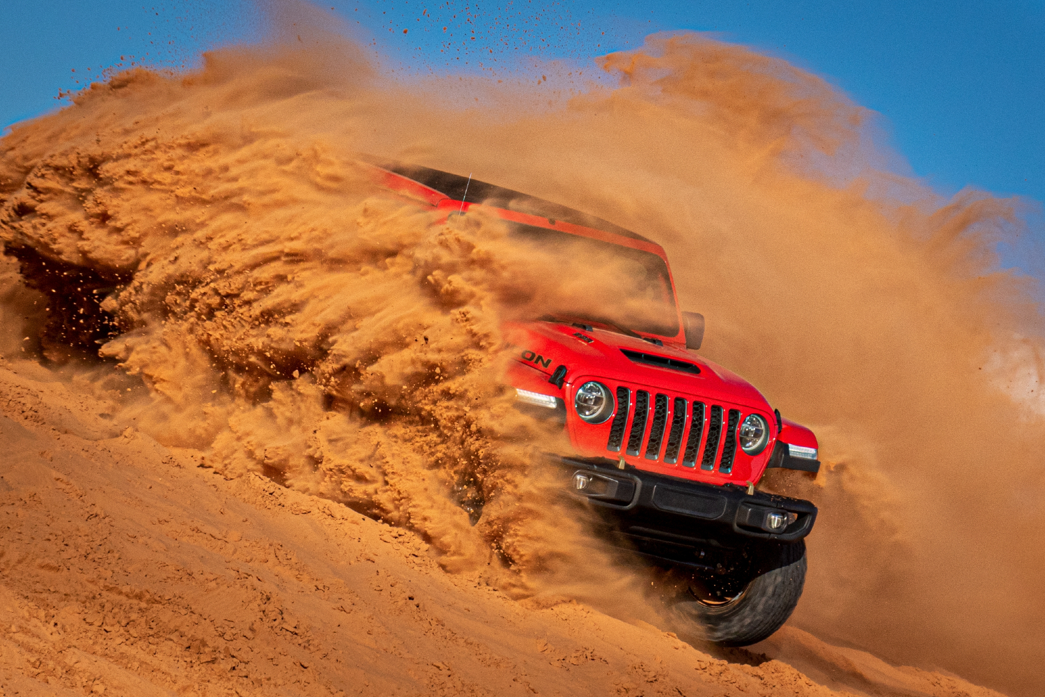 Jeep Wrangler running through the sand