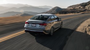 A silver 2022 Kia Forte driving in the opposite direction