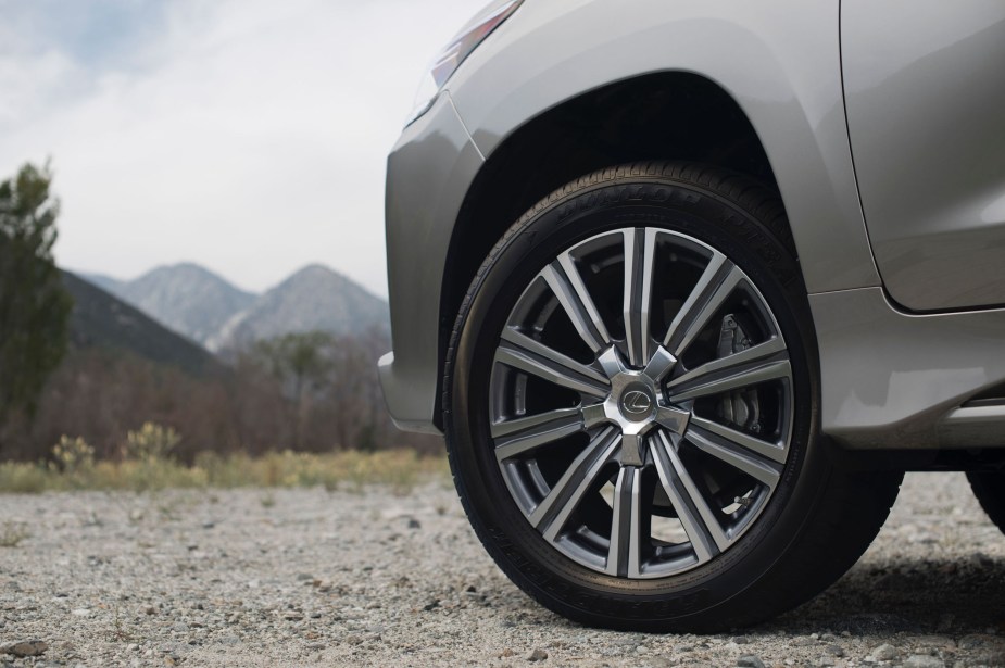 A Lexus SUV tire parked off-road on a trail