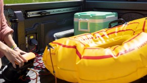 A 2022 Ford Maverick owner inflates a floatation device using a truck-bed outlet, essential for tailgating.