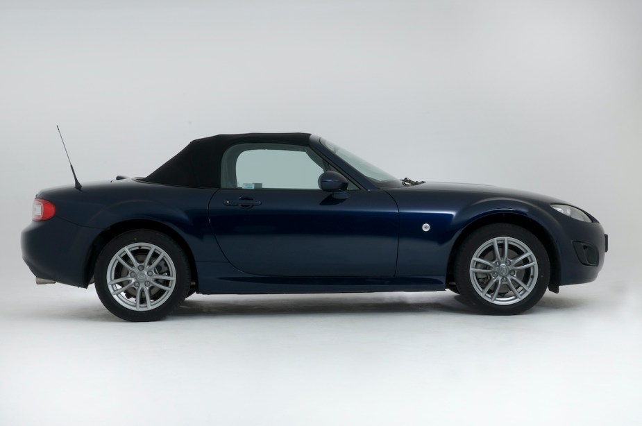 A side view of the 2010 Mazda MX-5 with the convertible top up.