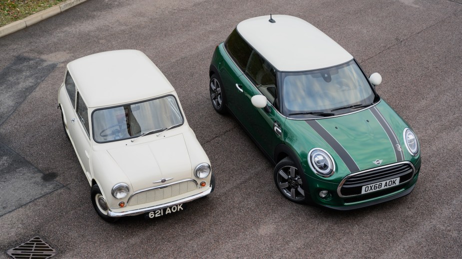 Publicity photo of a new and an old mini cooper parked side-by-side.