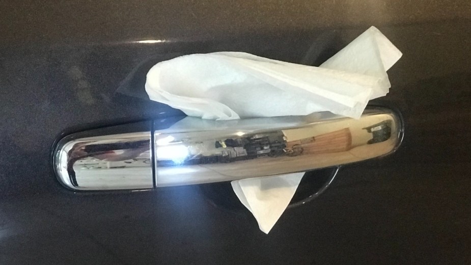 White napkin on a silver car door handle, highlighting poison napkin that hospitalized woman in Houston, Texas