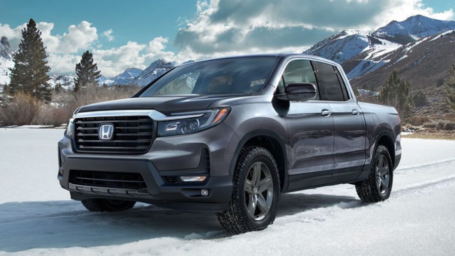 A 2023 Honda Ridgeline sits in a snowy mountain range. What kind of fuel economy does it have?