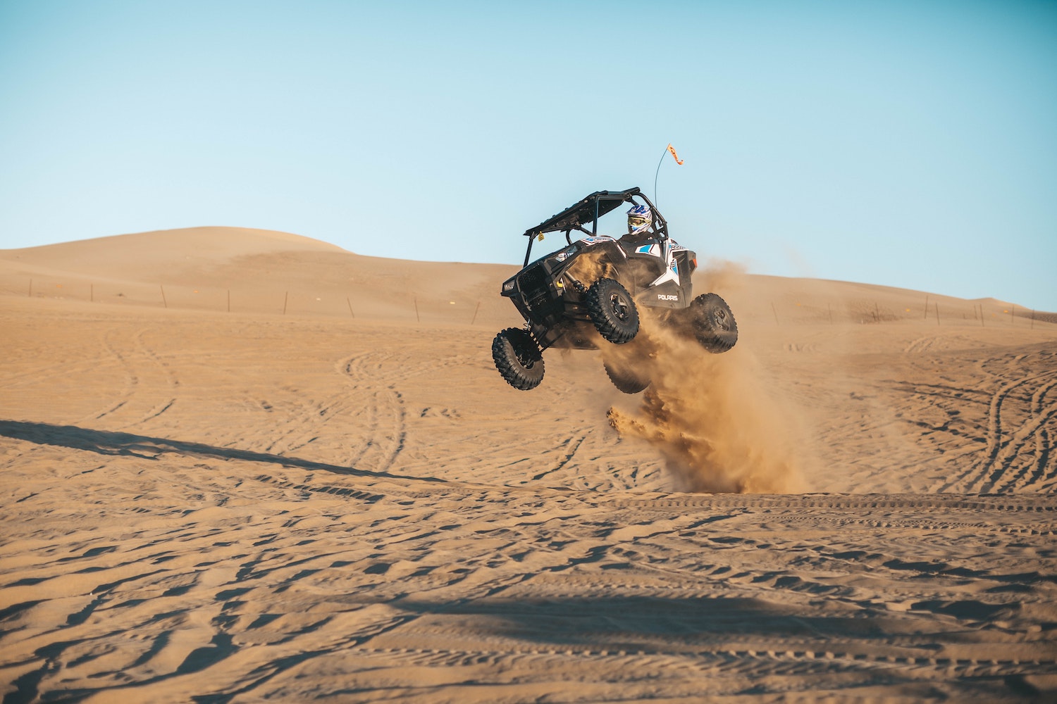 This is a side-by-side ATV taking a jump on the Oceano dunes of Pismo Beach