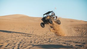 This is a side-by-side ATV taking a jump on the Oceano dunes of Pismo Beach