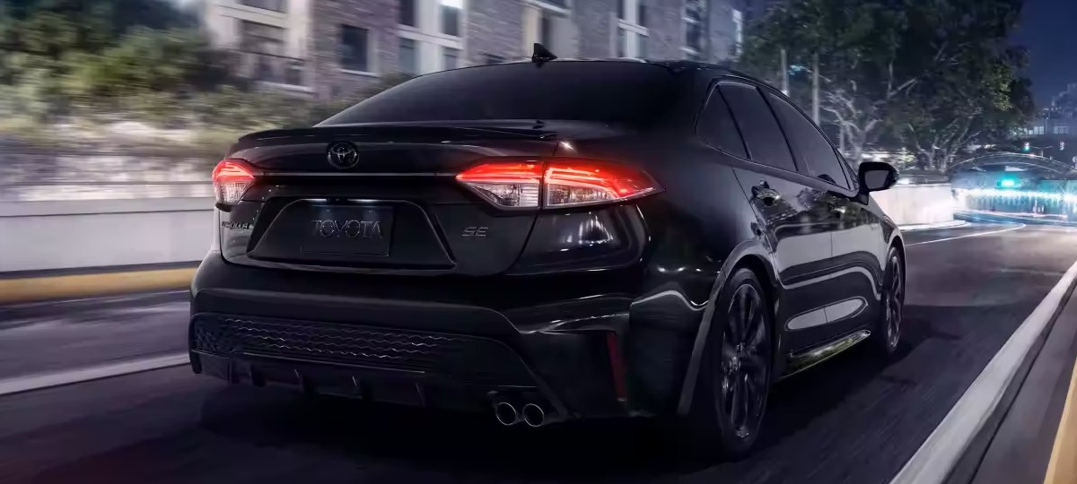 Rear angle view of Black Sand Pearl 2023 Toyota Corolla compact car