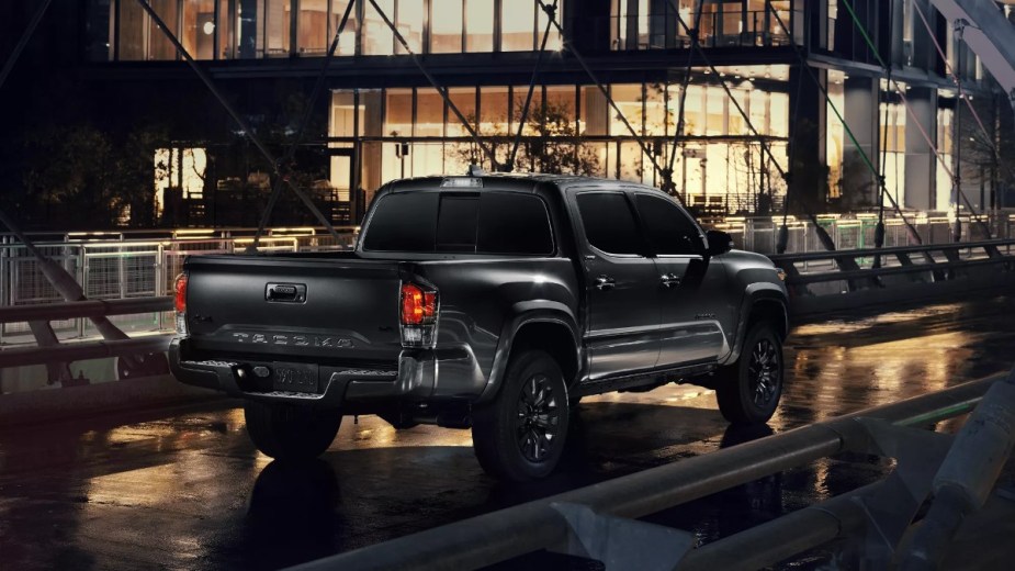 Rear angle view of black 2023 Toyota Tacoma pickup truck