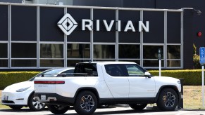 A white Rivian truck, an EV truck capable of towing.