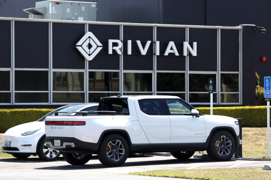 A white Rivian truck, an EV truck capable of towing.