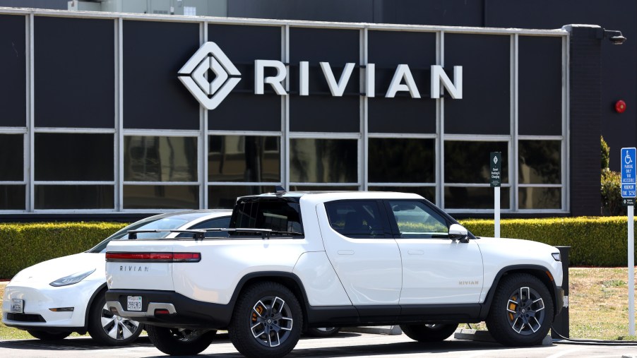 A white Rivian truck, an EV truck capable of towing.