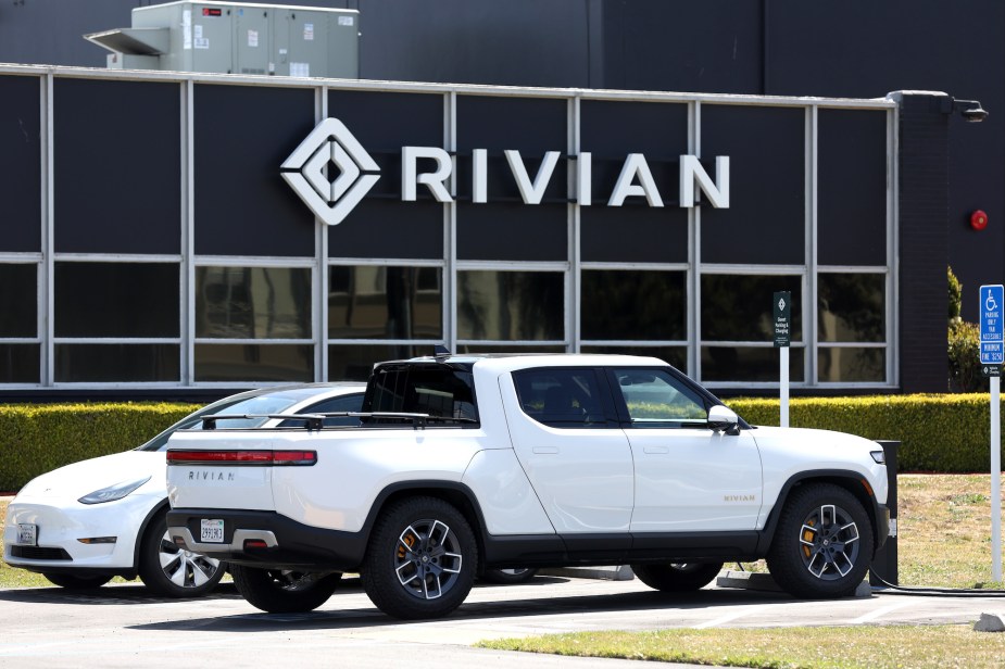 A white Rivian truck, an EV truck capable of towing. 