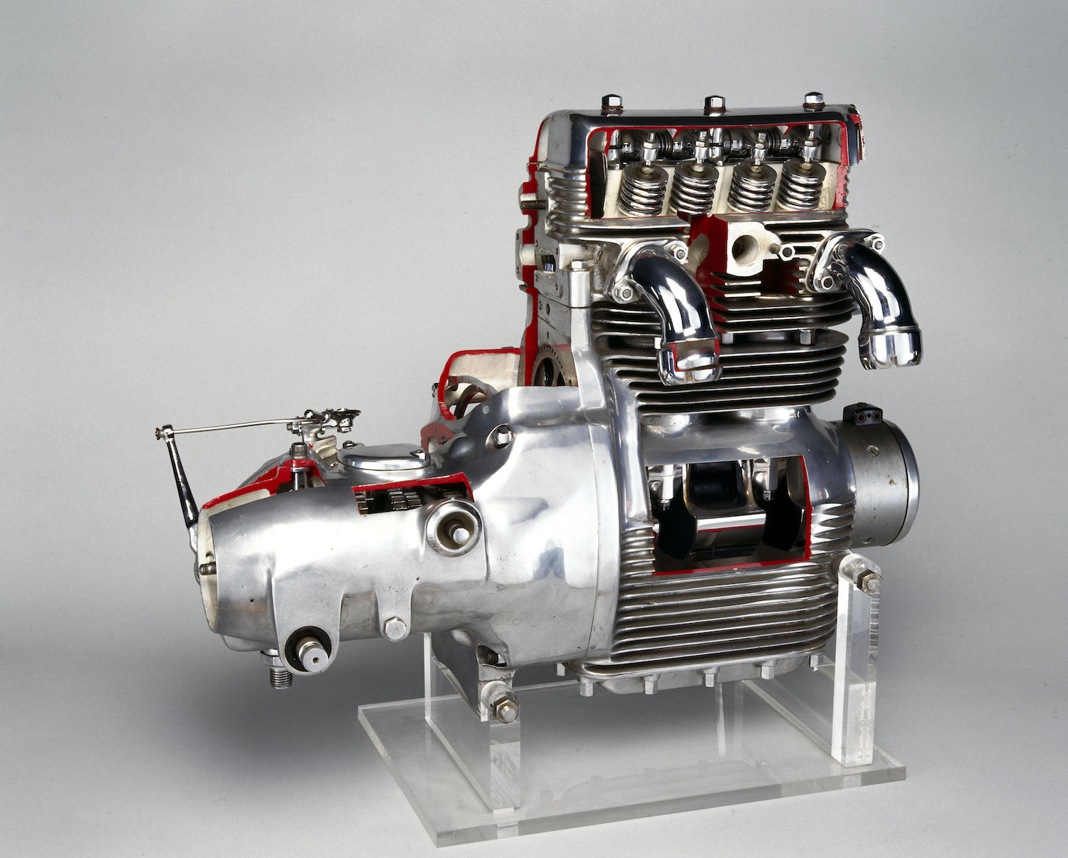 Cutaway engine with its camshafts and valves visible.