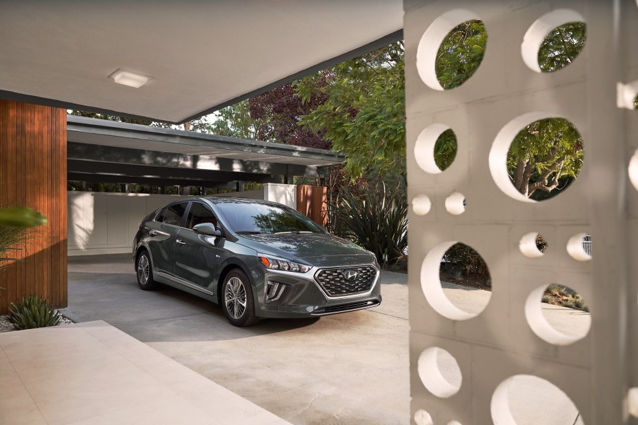 A gray 2022 Hyundai Ioniq Plug-in Hybrid in a futuristic home's driveway
